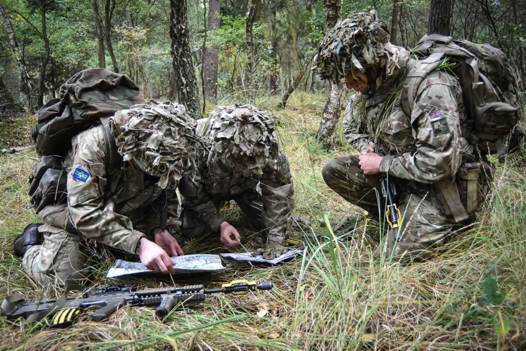 Pictured are members of C Squadron from the Queen's Royal Hussars checking their position on a map during a Junior NCO Cadre.
