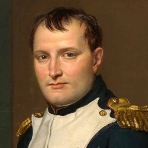 A portrait of a man in a military uniform with gold shoulder epaulettes, short dark hair, and a serious expression, set against a plain background.
